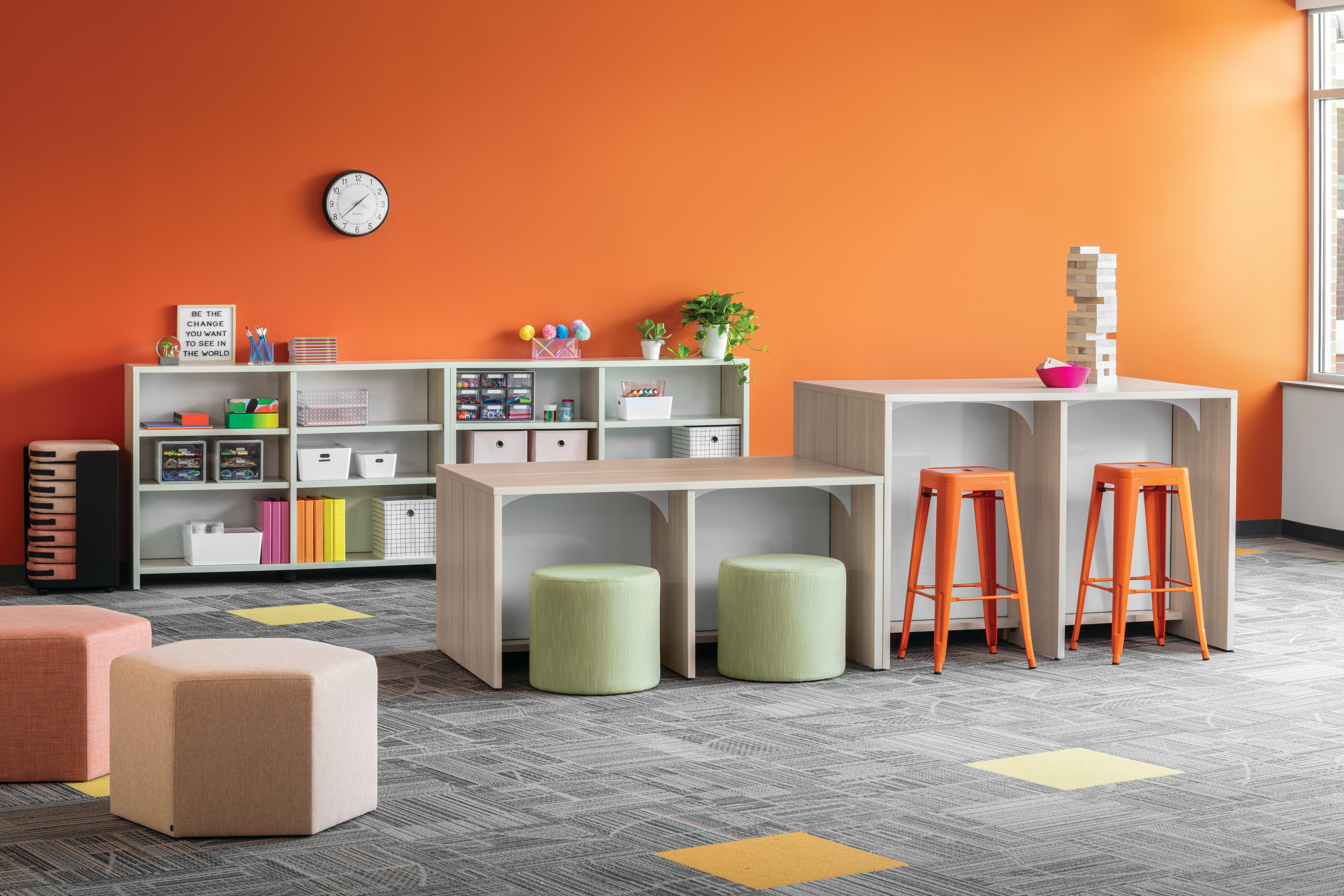 Storyline Linear Bookcases and Bistro Tables with Tangram Poufs and Flock Minis.