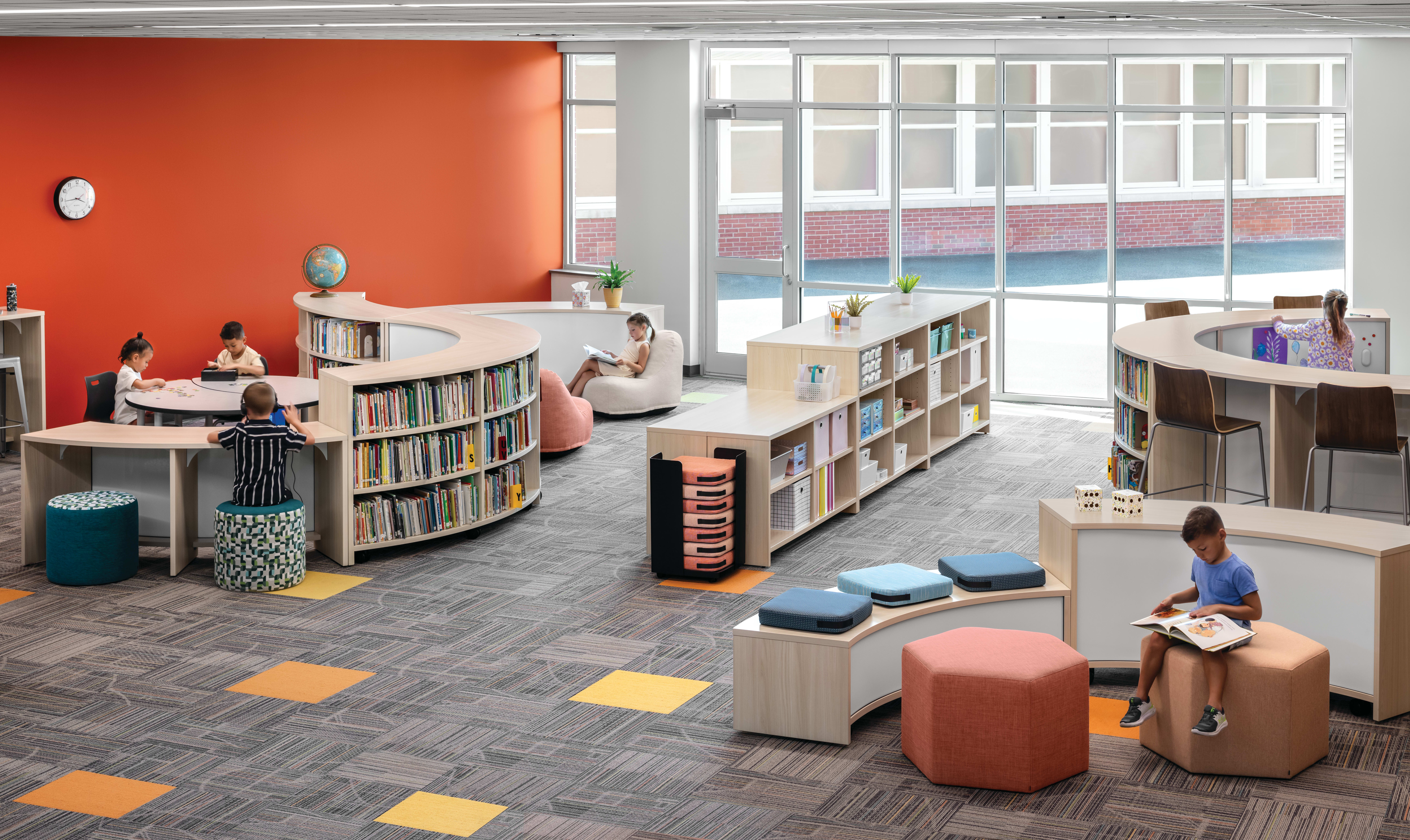 Storyline Bookcases and Bistro Tables with Confetti Floor Cushions and Lounges, Tangram Poufs, and Flock Minis.