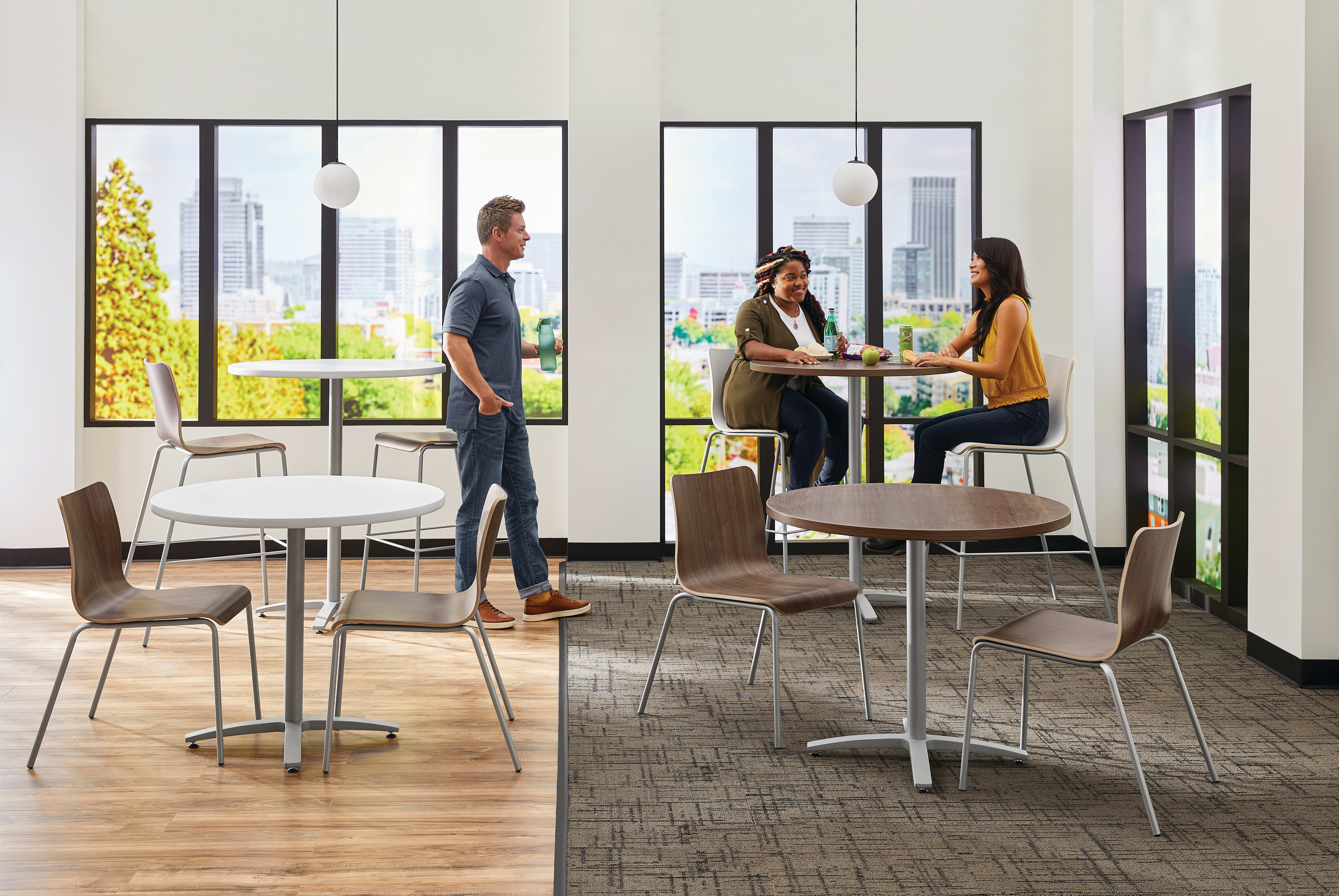 Between Standing and seated height tables with Ruck chairs in a café area