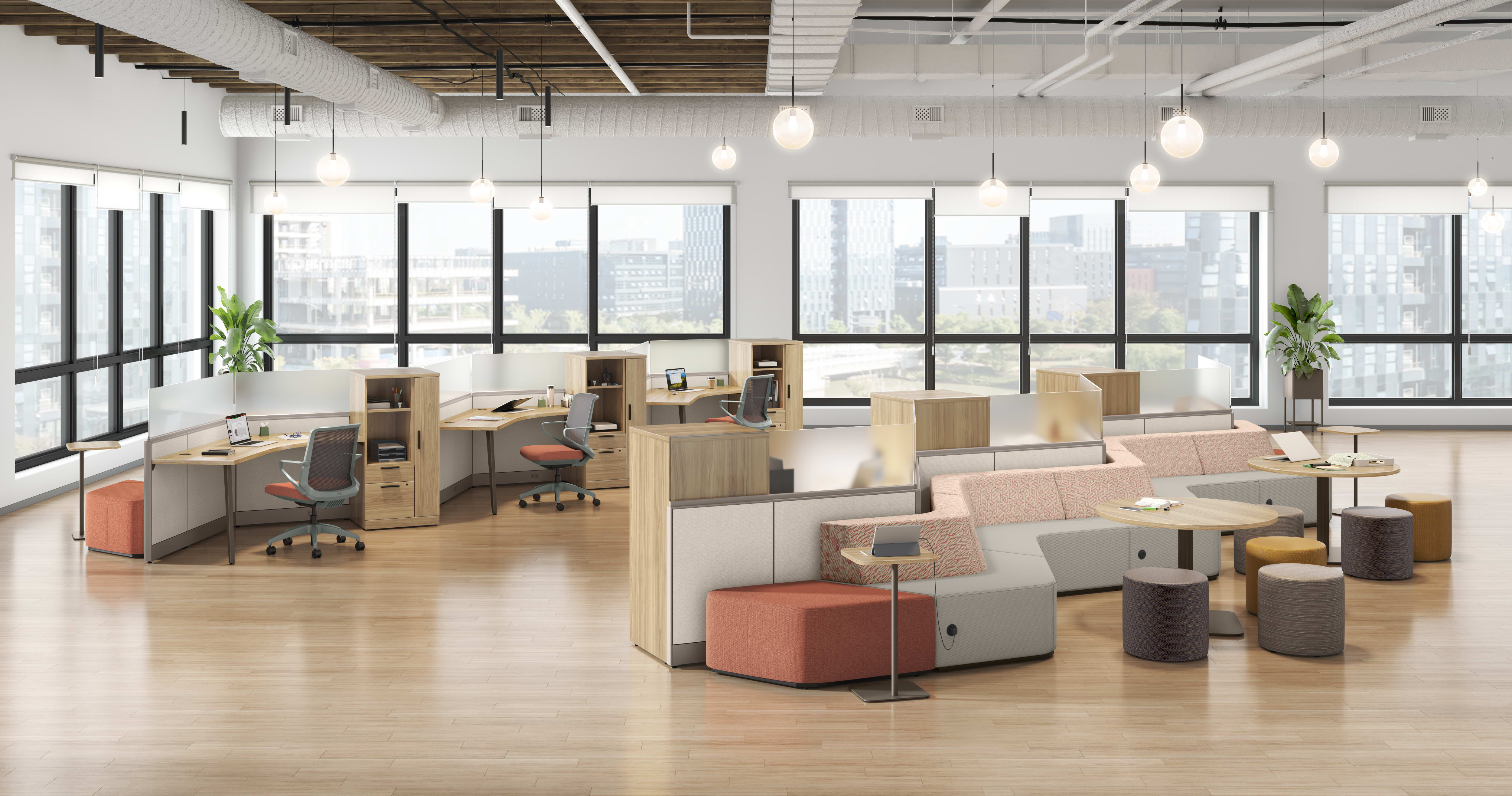A modern, open-concept office space with cubicles, seating areas, and large windows providing ample natural light.
