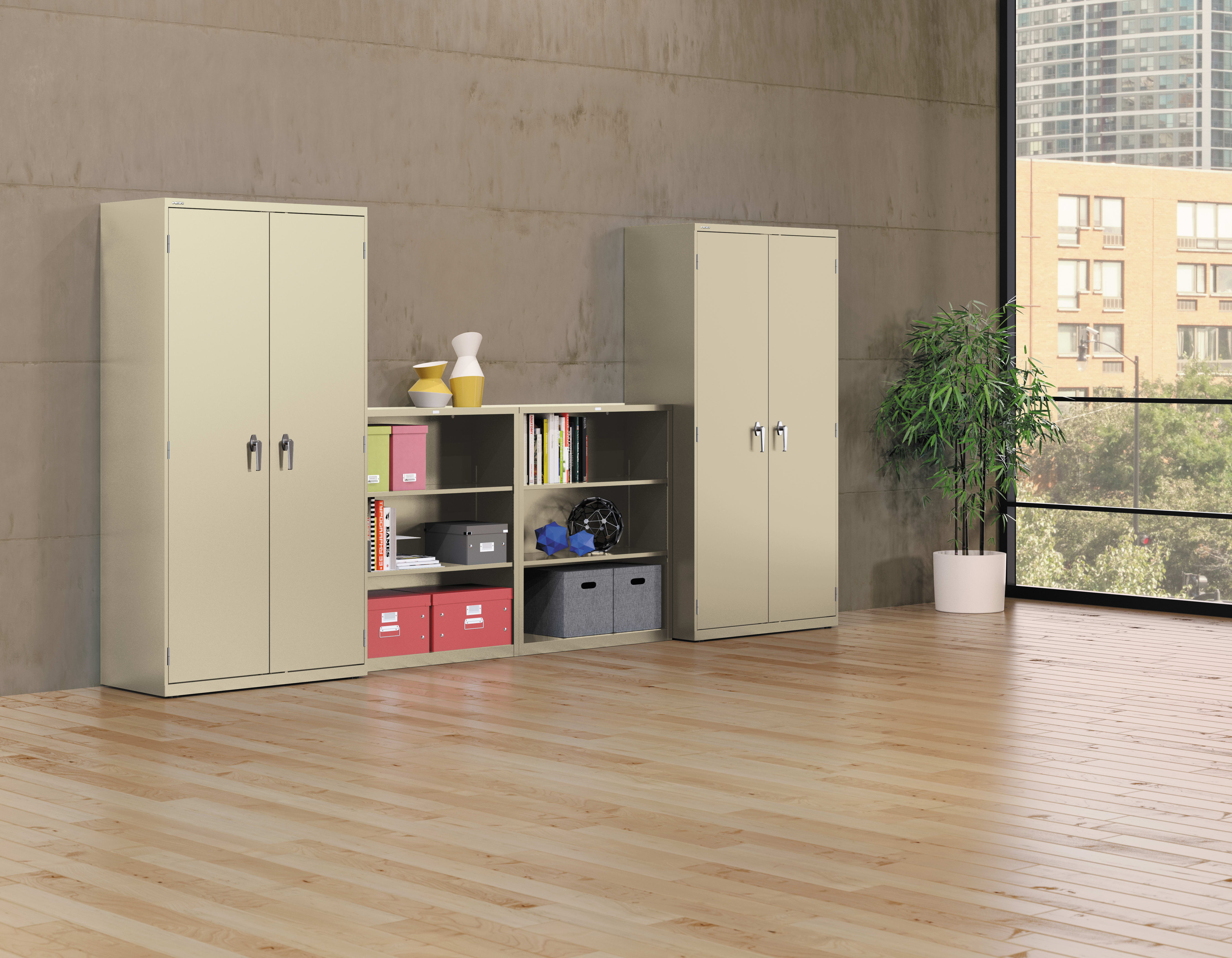 The image depicts a modern, minimalist office or home interior with beige cabinets, shelves, and a potted plant, set against a plain concrete wall and wooden flooring.