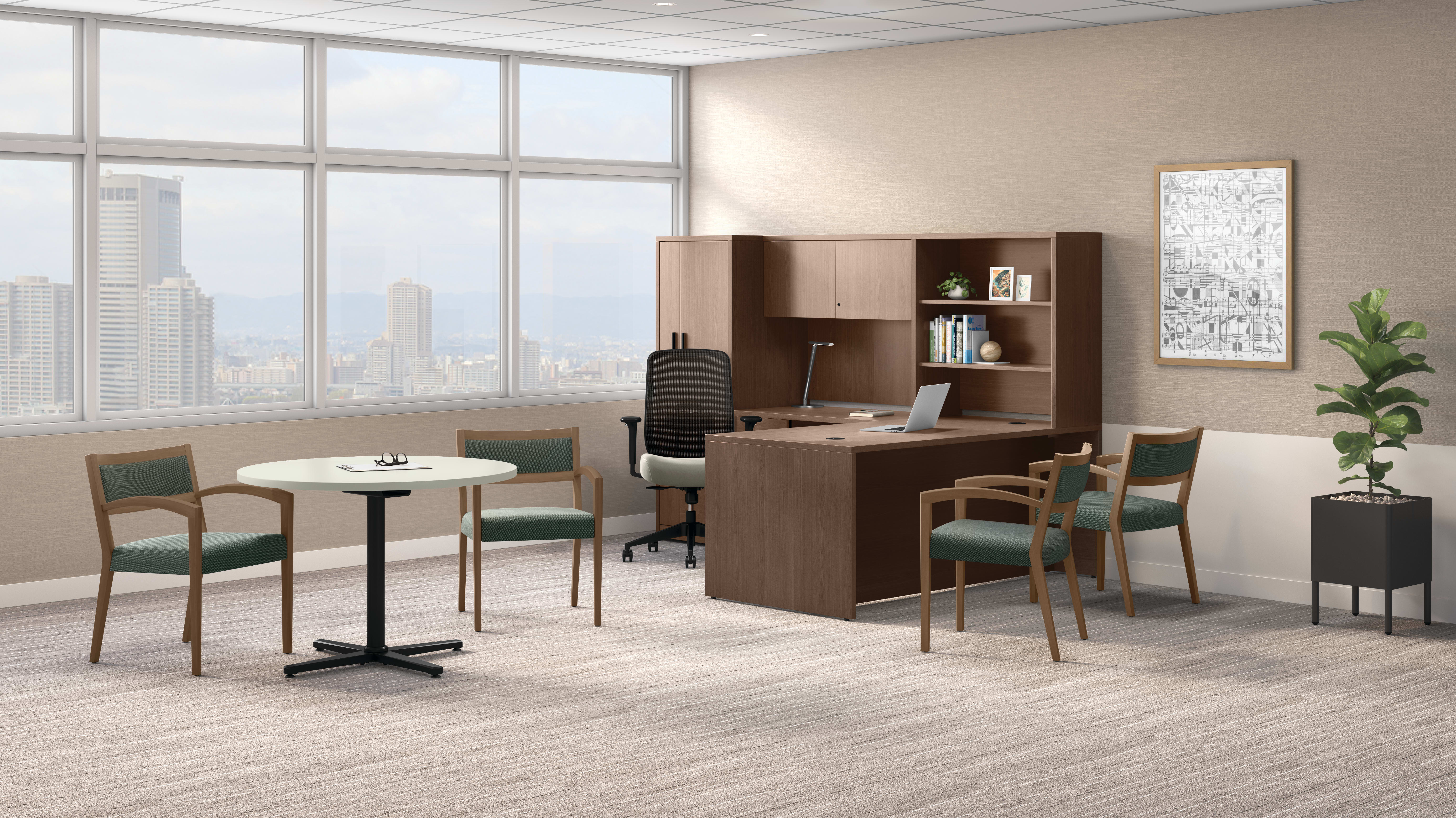 Private office with wood desk and hutch, green guest chairs, round meeting table, floor plant, and large windows with city skyline views.