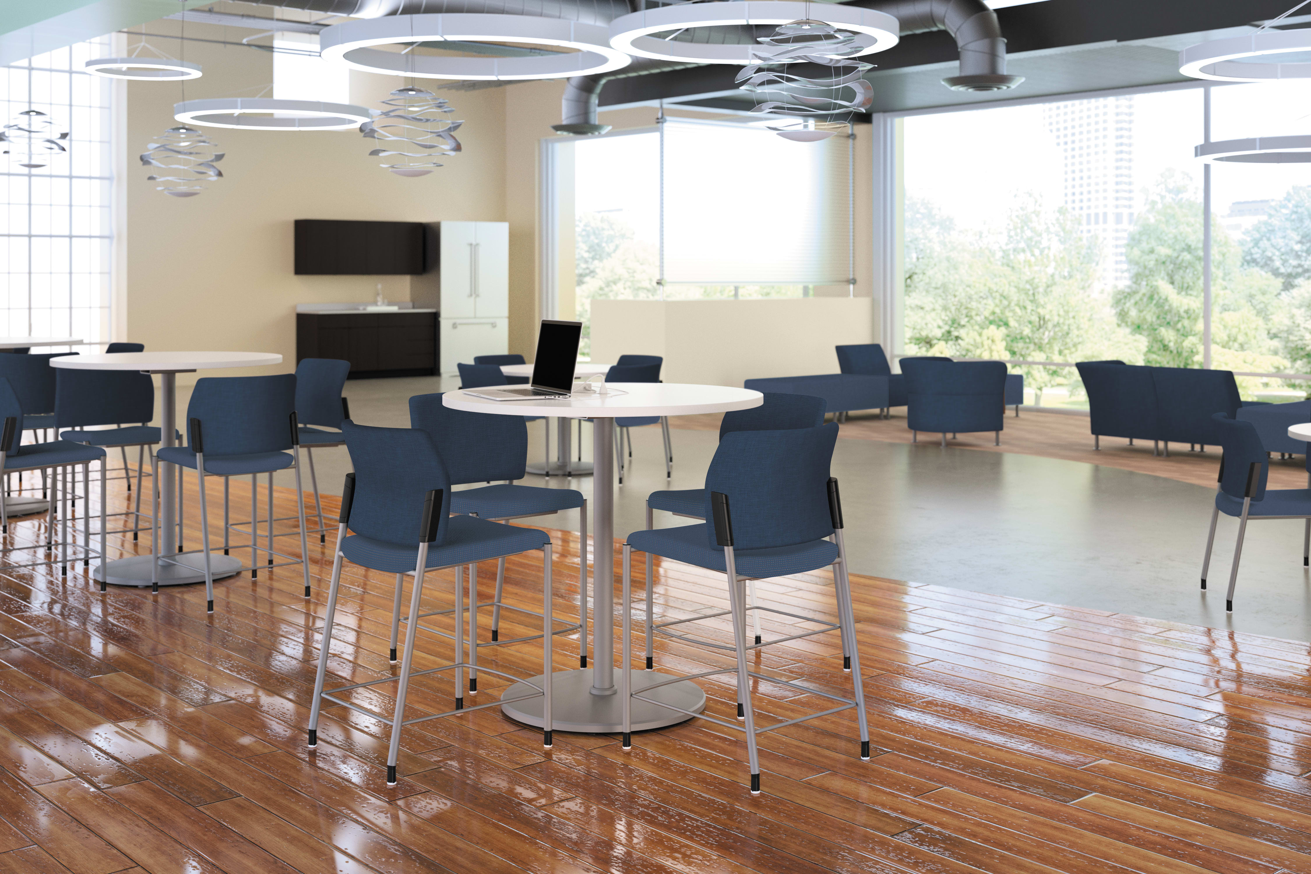 A modern and spacious office or meeting space with high ceilings, large windows, and sleek furniture including round tables and black chairs arranged in a casual, collaborative setup.