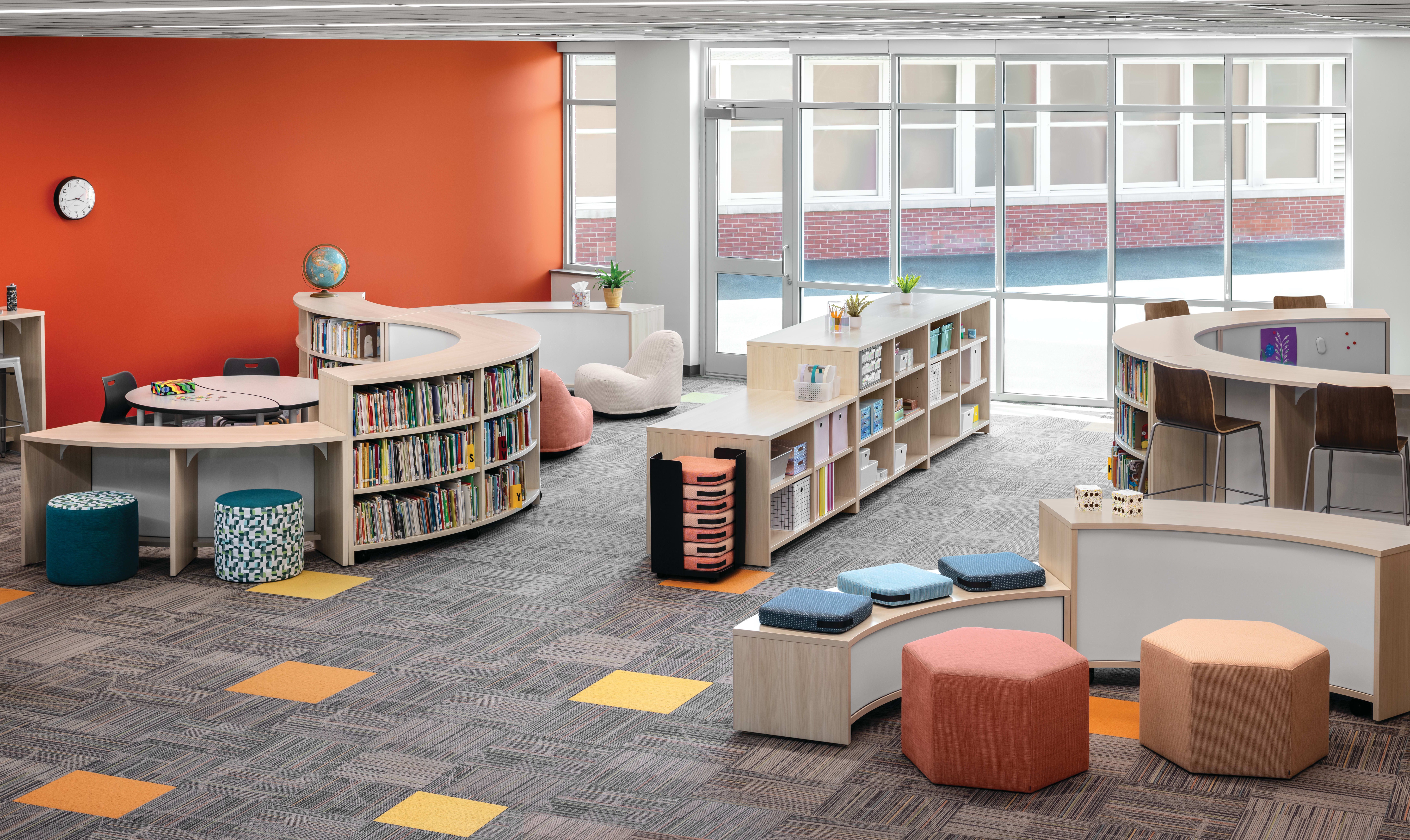 Storyline Bookcases and Bistro Tables with Confetti Floor Cushions and Lounges, Tangram Poufs, and Flock Minis.