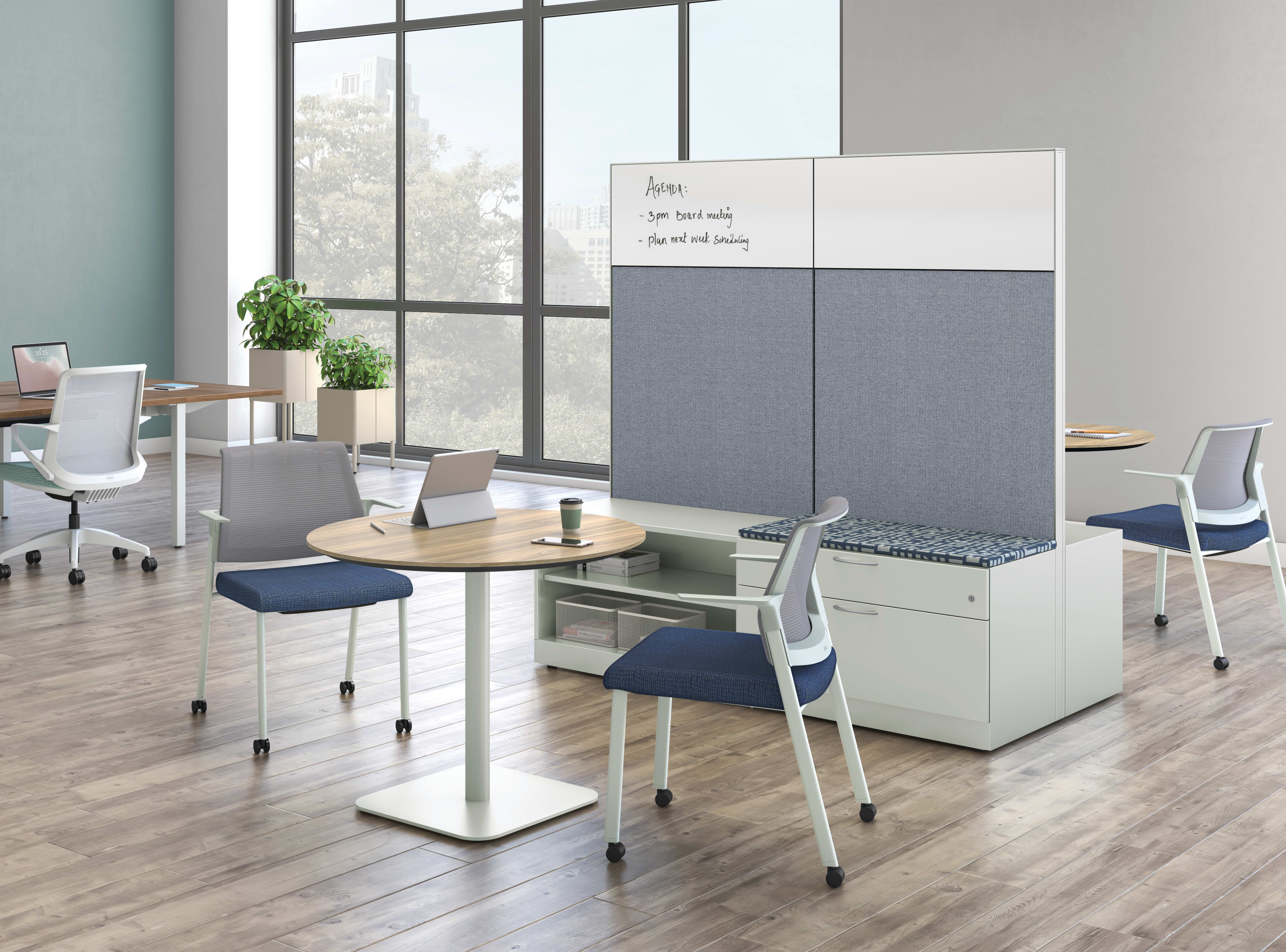 A modern and minimalist office space with a whiteboard, desks, chairs, and potted plants, set against a backdrop of large windows overlooking an outdoor scene.