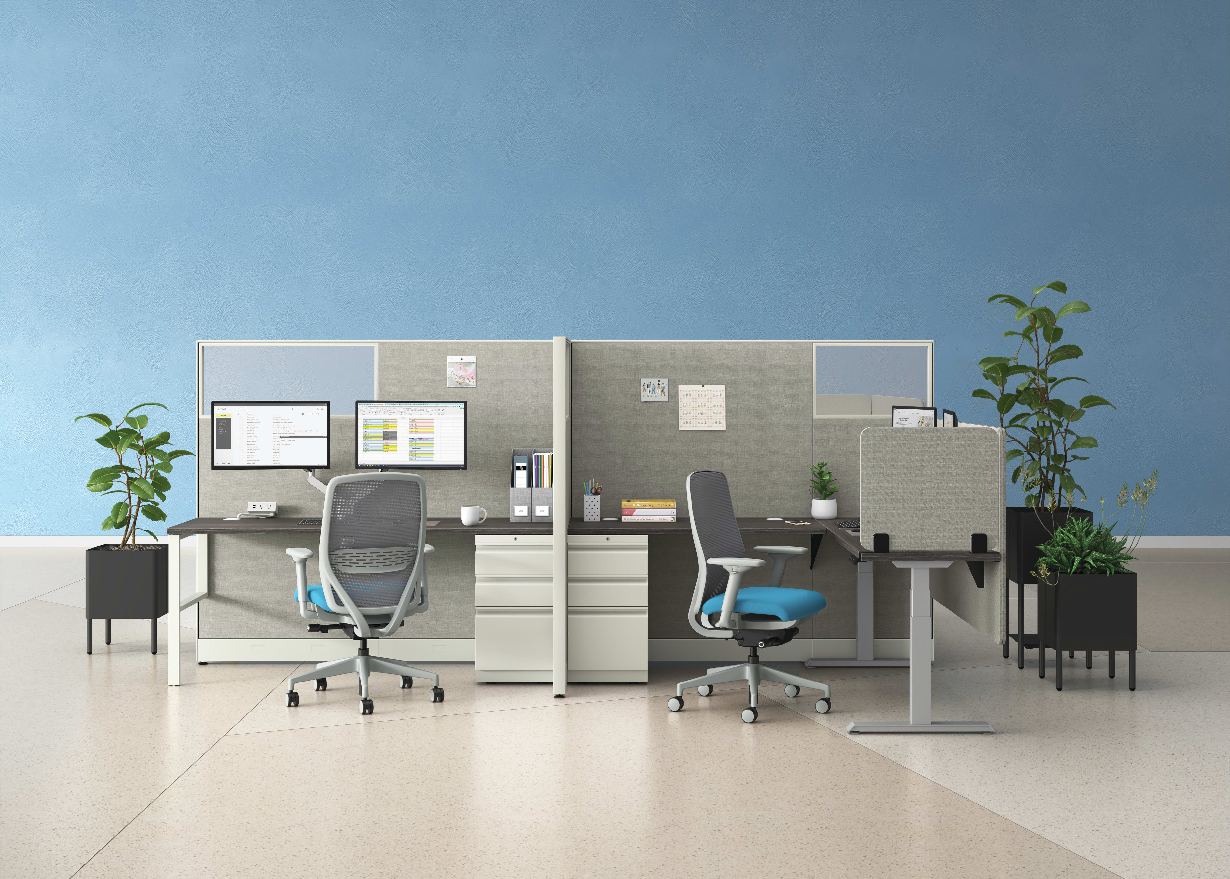 An open plan workstation arrangement with Nucleus task chairs and height-adjustable desks.