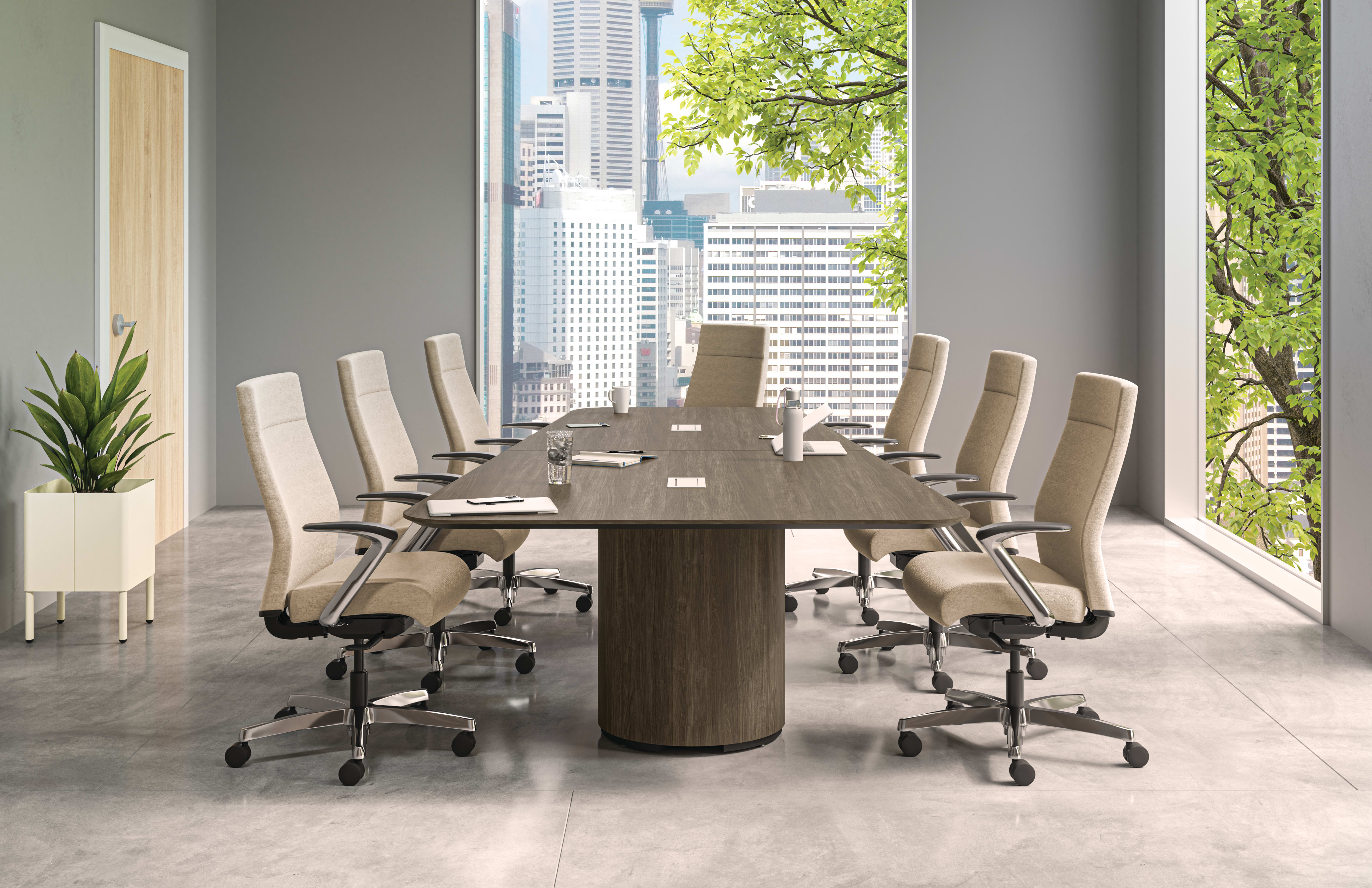 A modern and minimalist conference room with a large wooden table surrounded by white office chairs, overlooking a cityscape through the large windows.