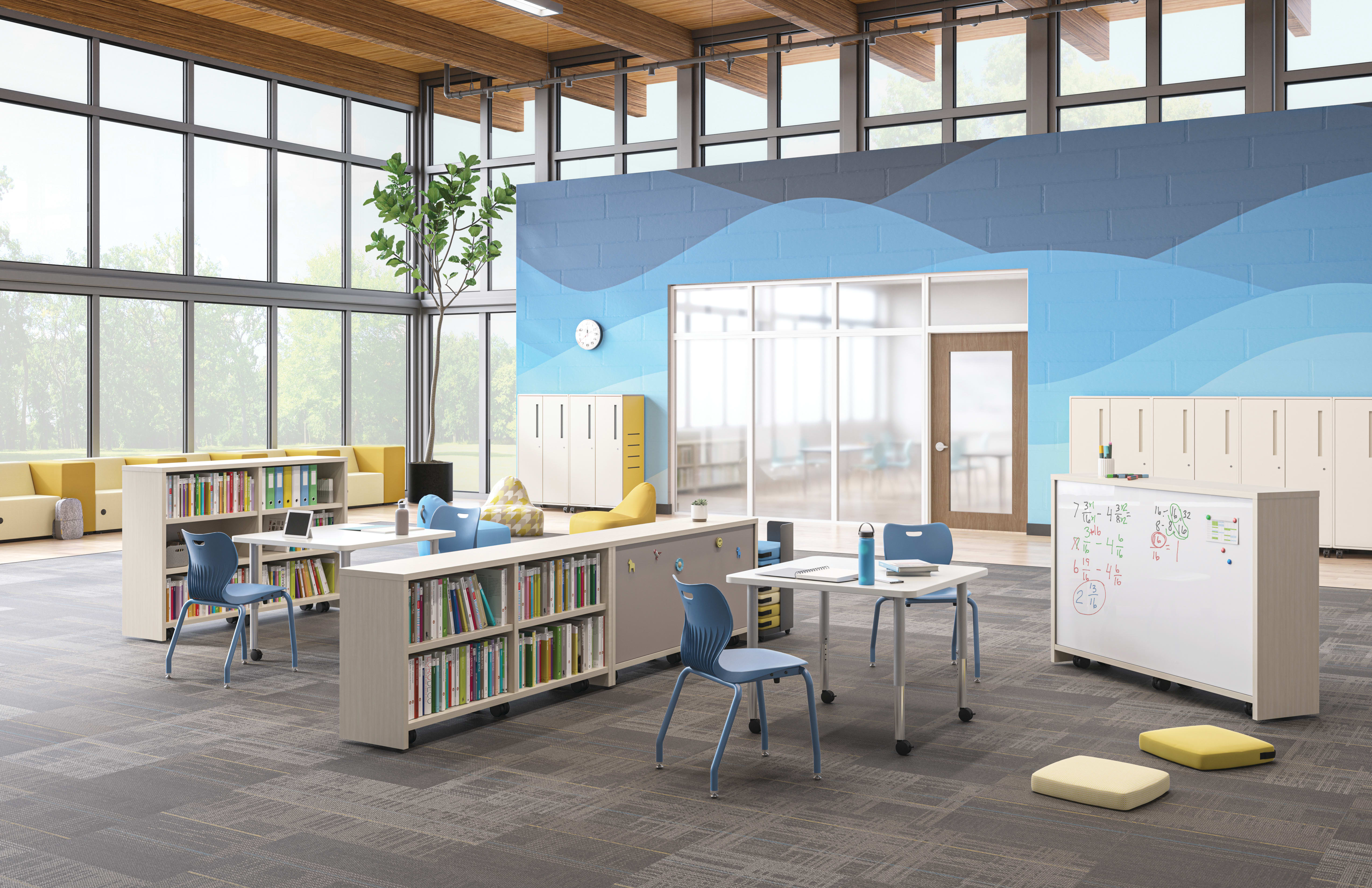 Open space outside of a classroom featuring Storyline bookcases and Build tables as a place for students to study.