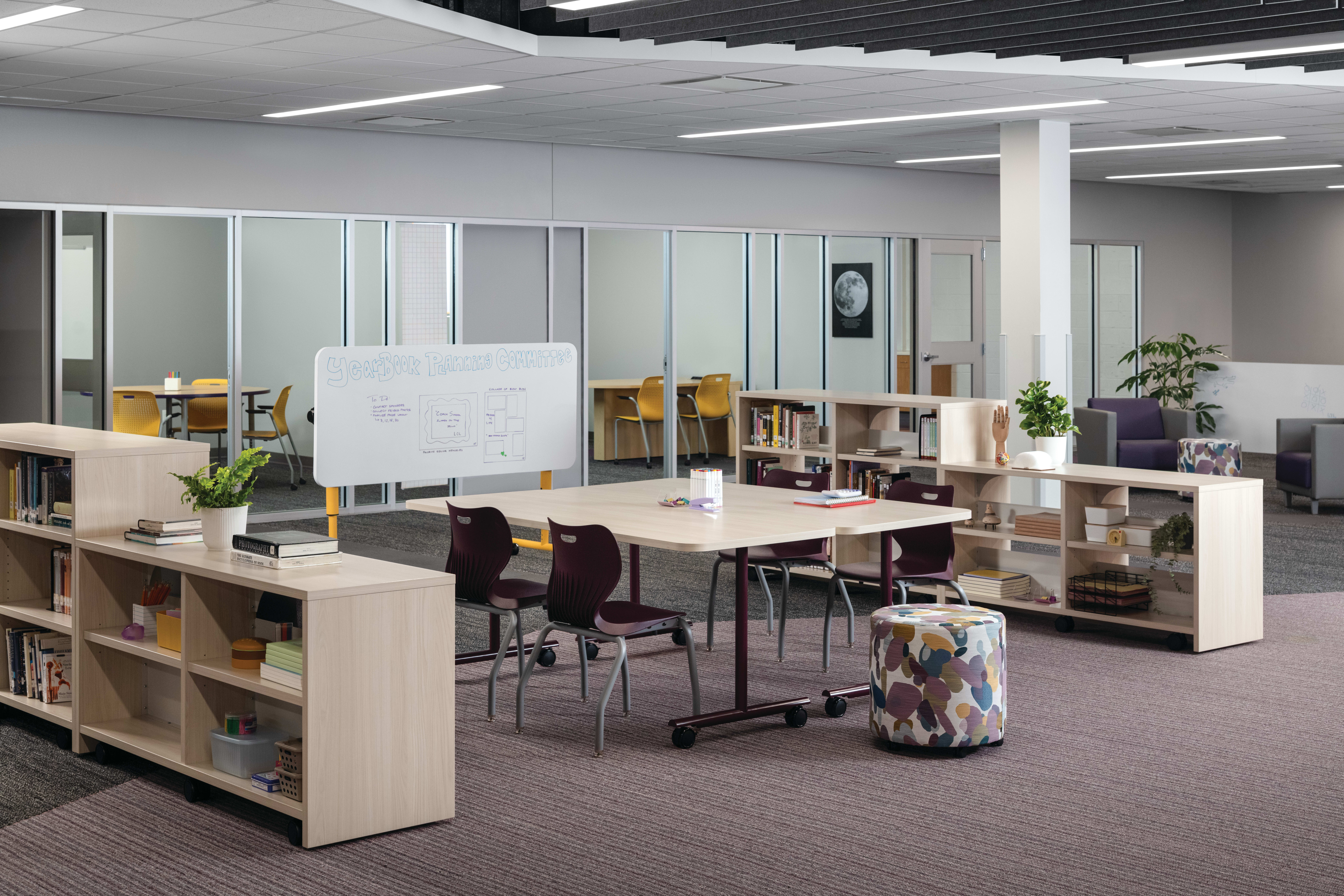Field Trip tables with purple SmartLink chairs in a Multi-media Center with Storyline bookcases.