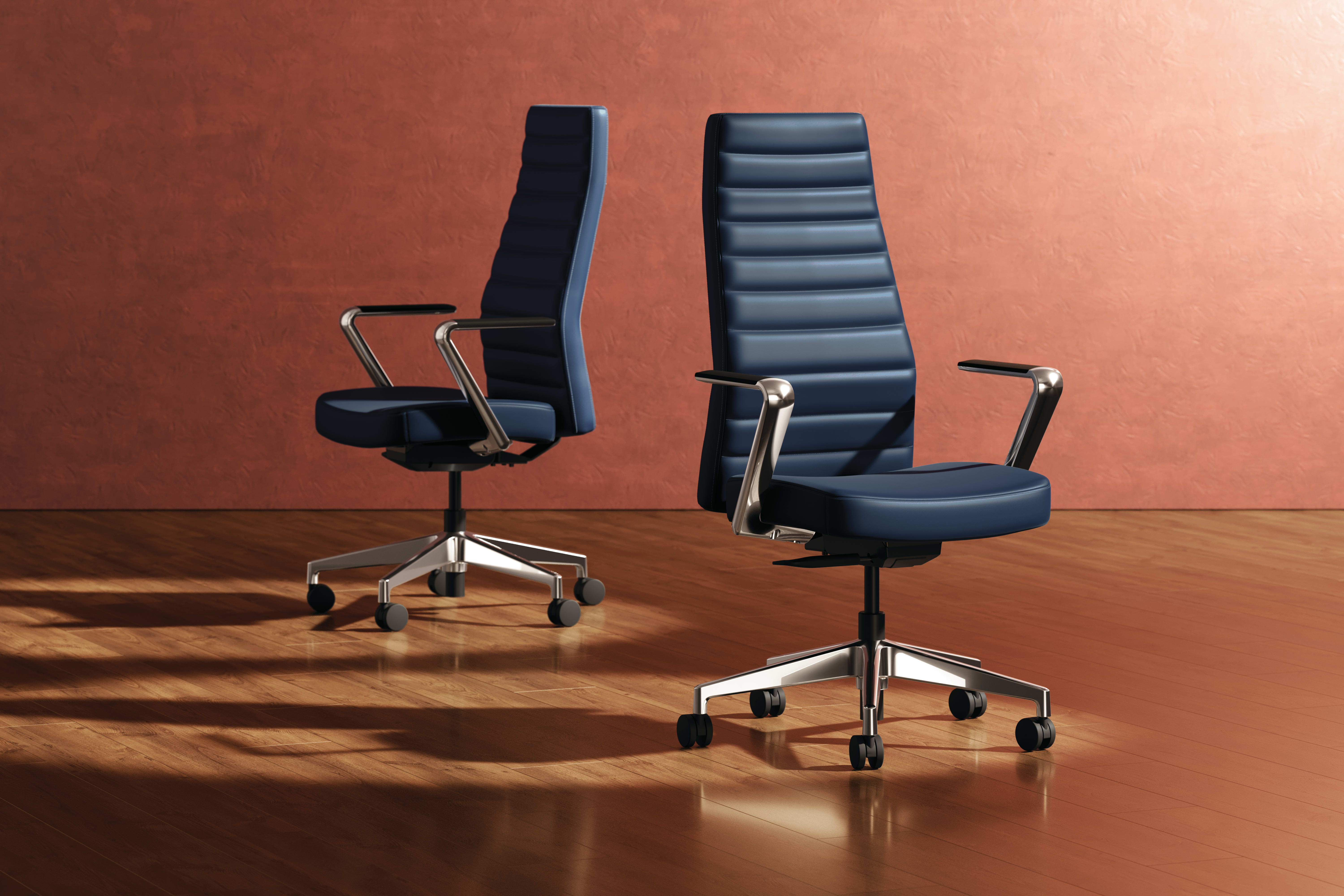 Two modern, high-back office chairs with black leather upholstery and chrome frames sit on a wooden floor against a warm, reddish-brown background.