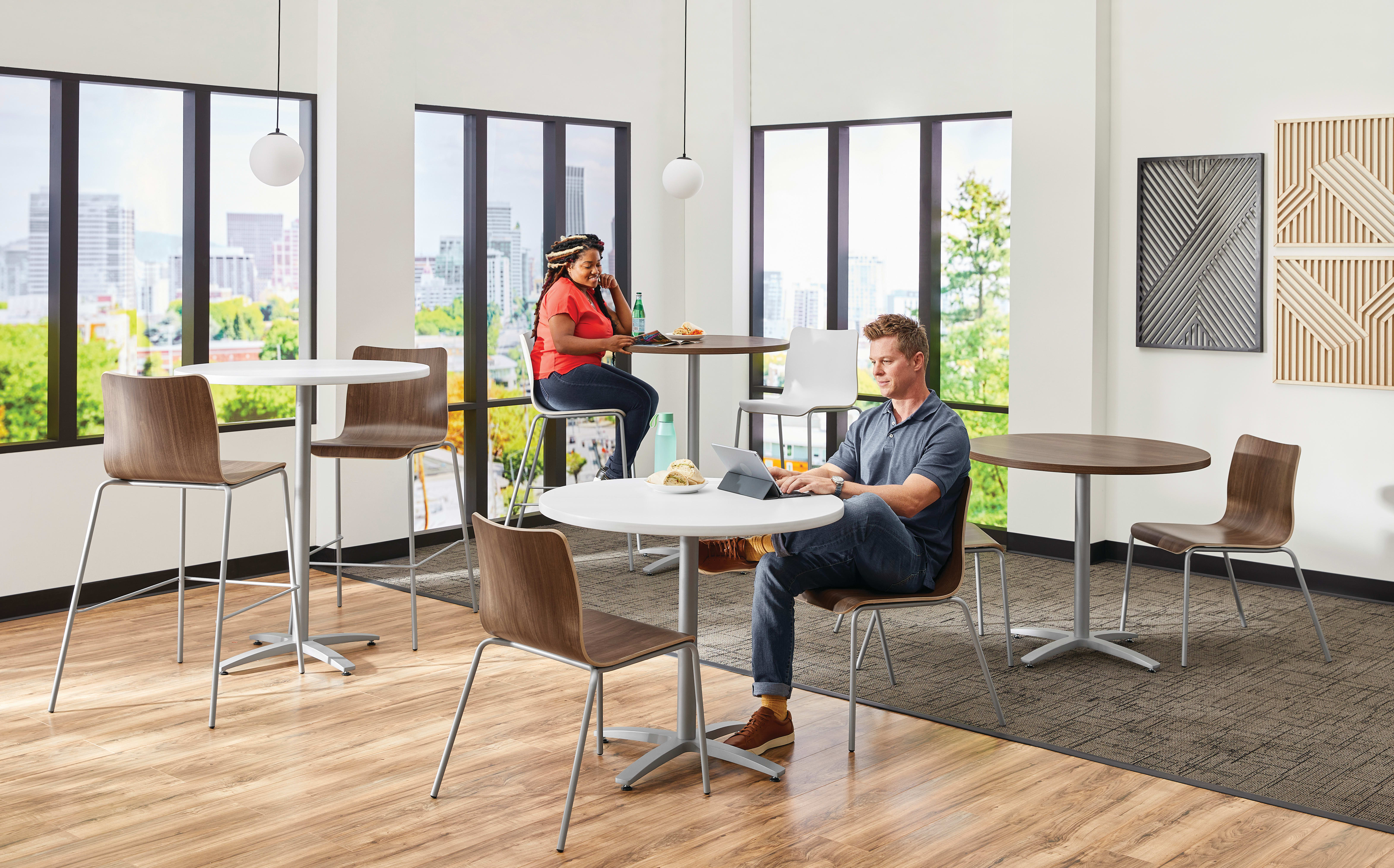 Between Standing and seated height tables with Ruck chairs in a café area