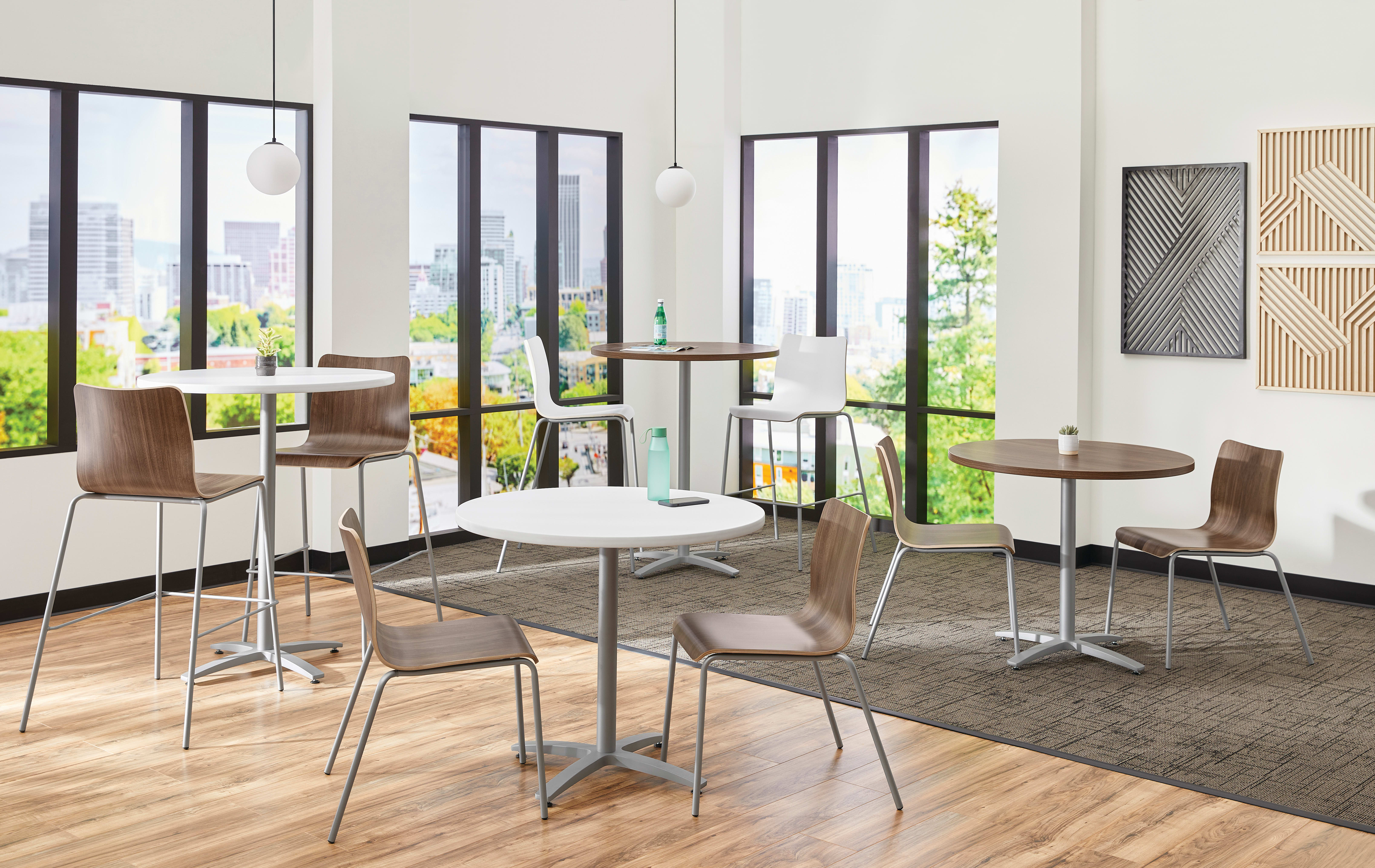 Between Standing and seated height tables with Ruck chairs in a café area