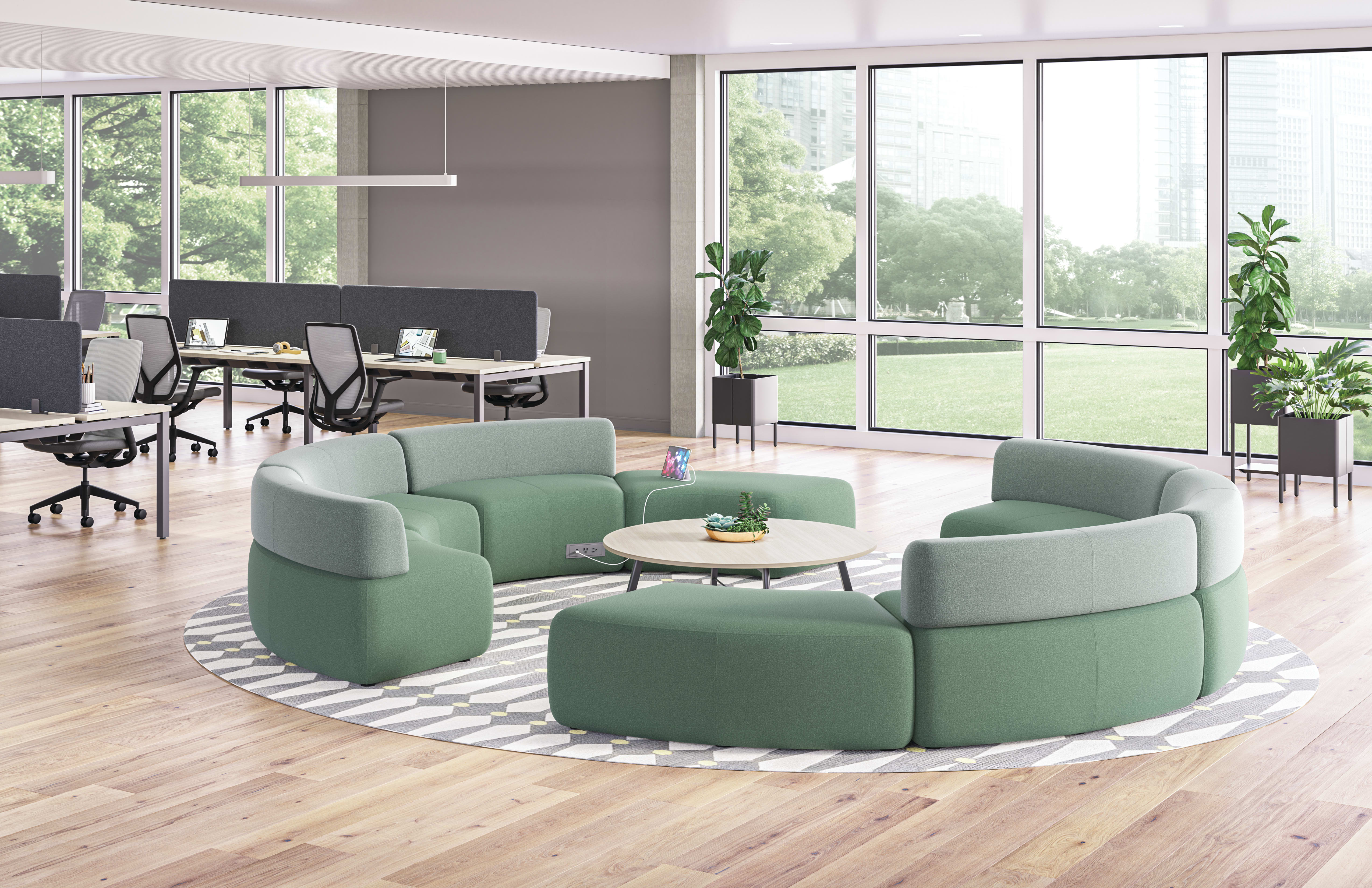 SoCo multi-fabric modular lounge in collaborative area with Scramble table and Sculpt planters near Empower workstations.
