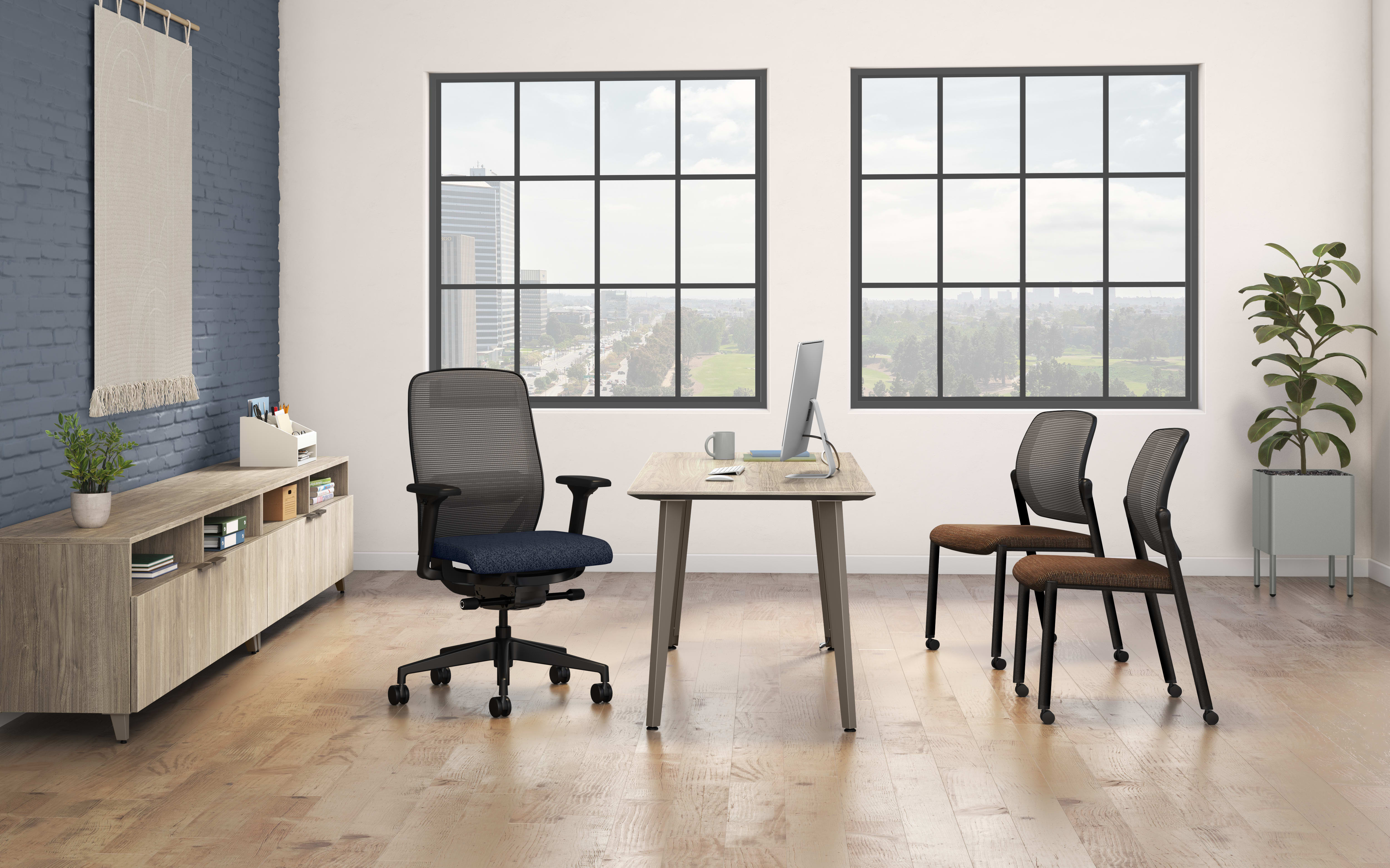A modern and minimalist office space with large windows, a wooden desk, office chairs, and a storage unit against the wall.