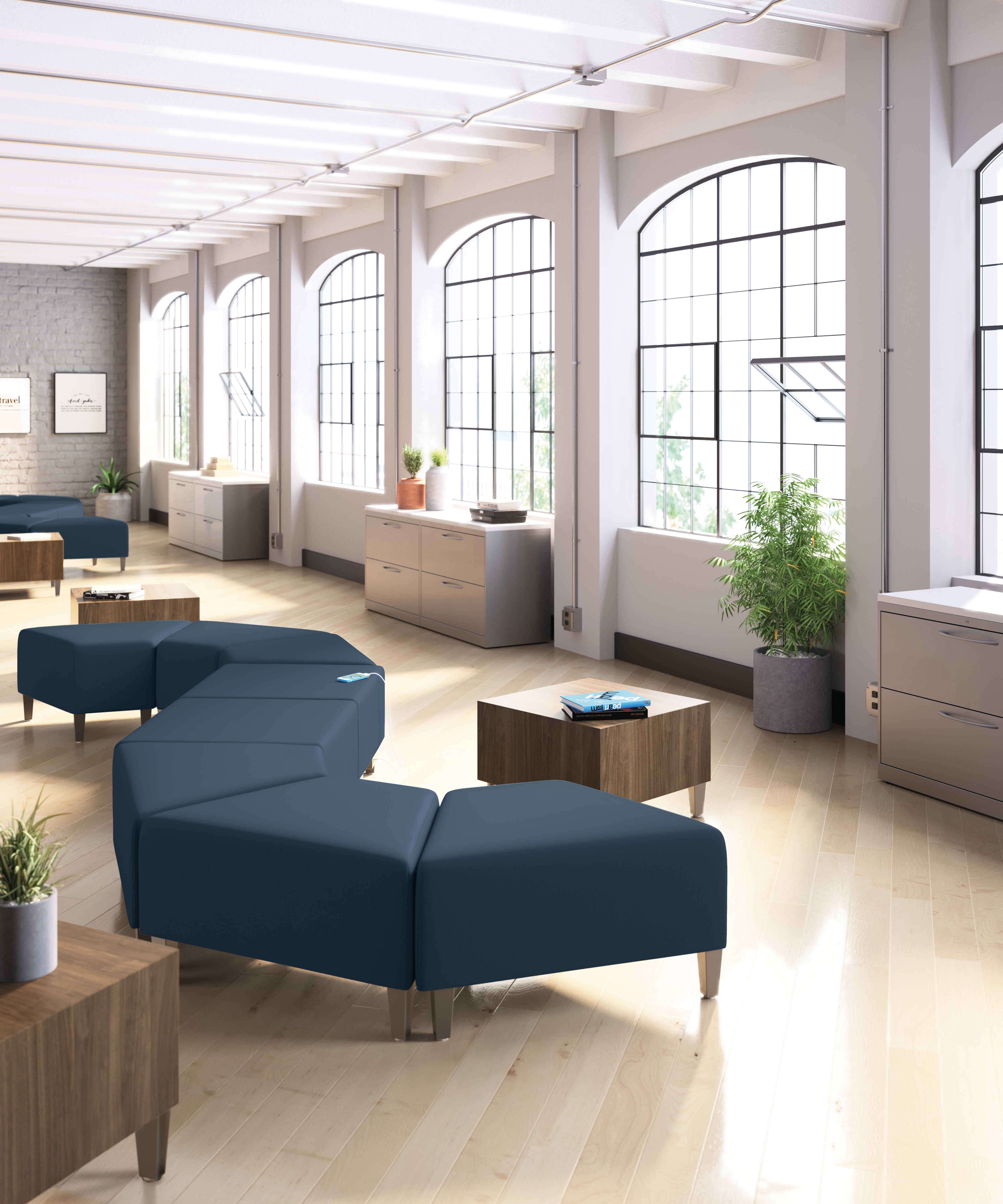 A modern and spacious office space with large windows, wooden furniture, and comfortable seating arrangements.
