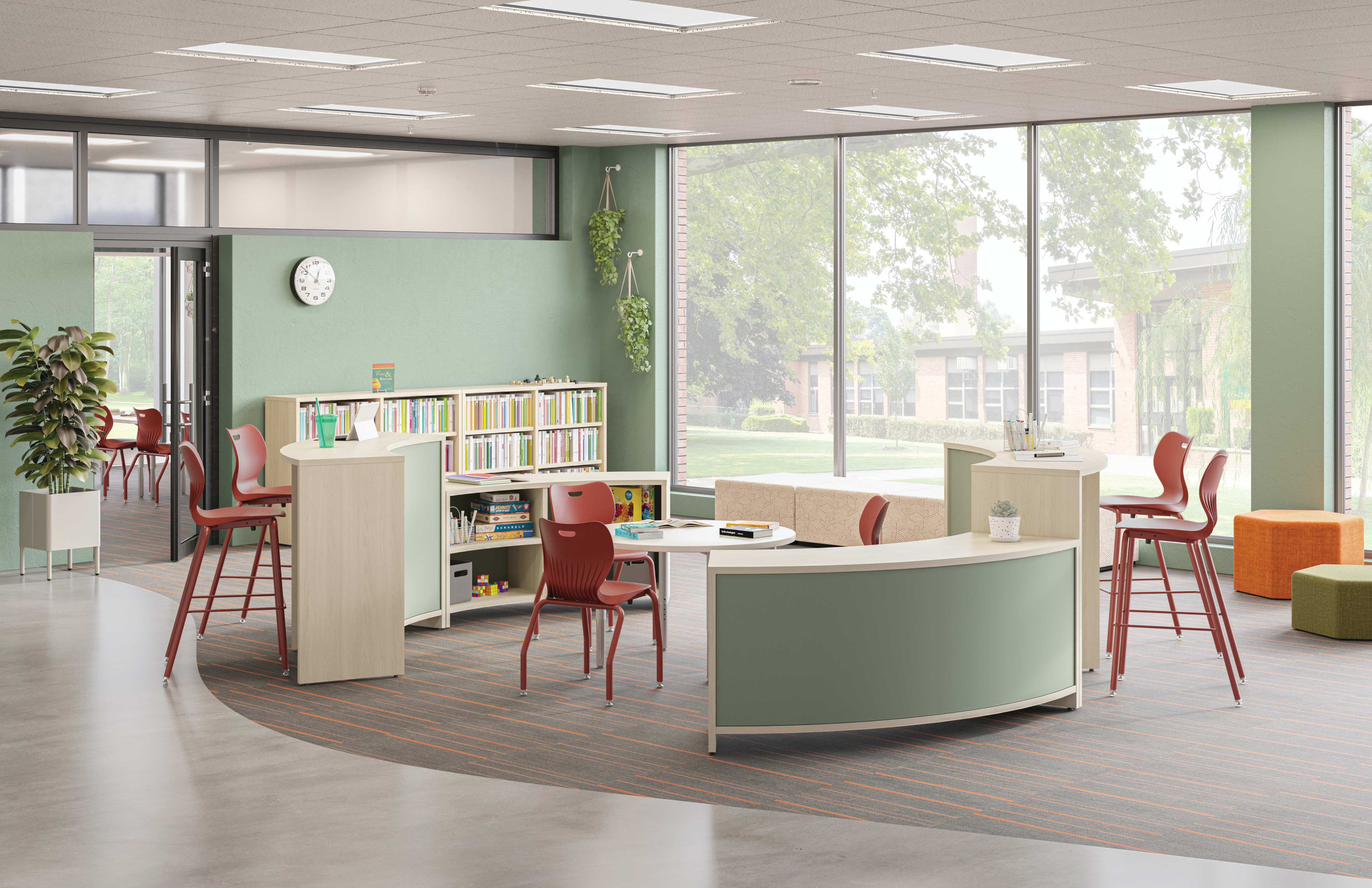 A modern, open-concept office space with a mix of functional and decorative elements, including a curved desk, bookshelves, and colorful chairs, set against a backdrop of large windows overlooking a lush outdoor environment.