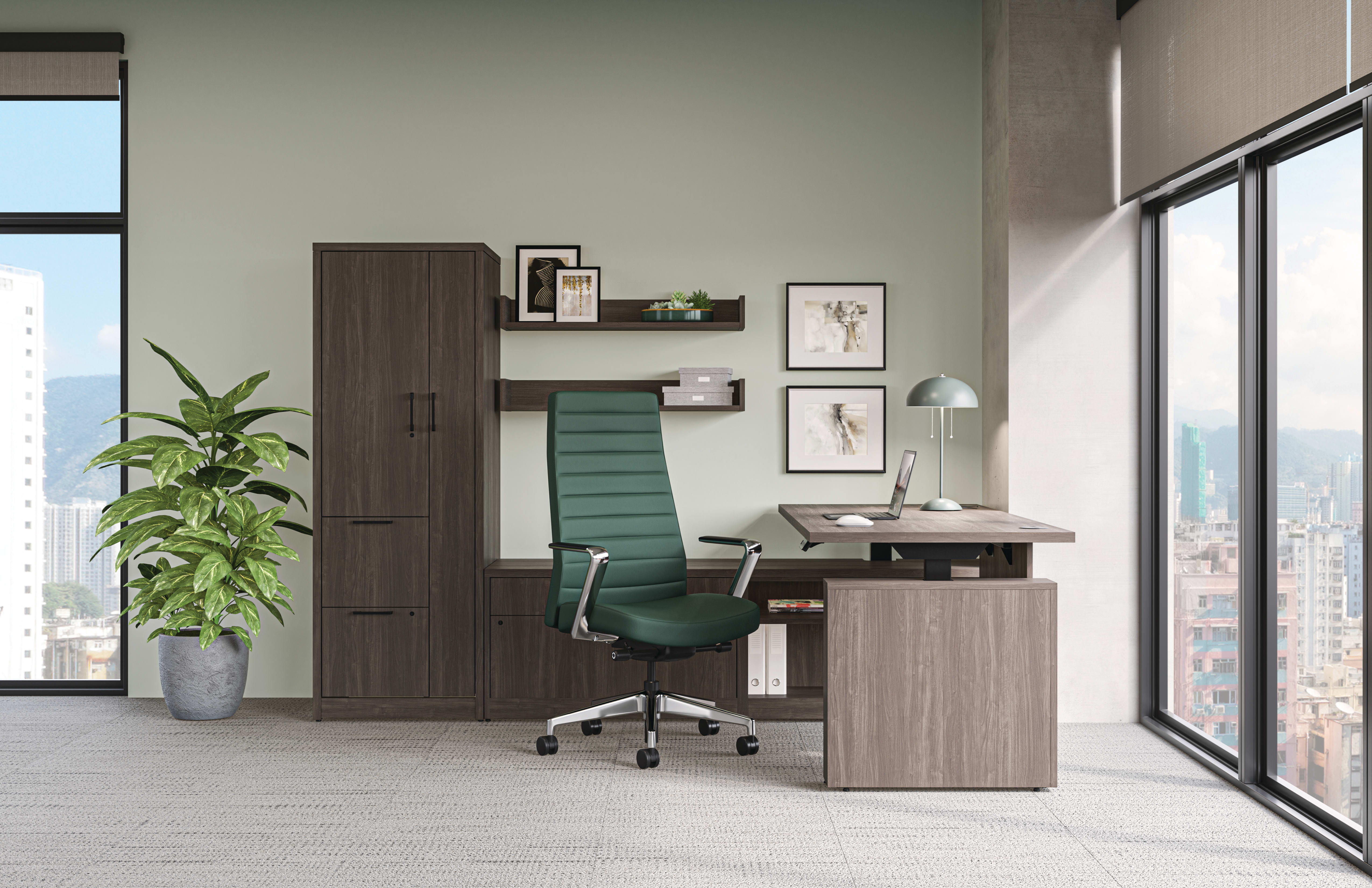 Modern private office with wood desk and storage cabinets, green task chair, framed wall art, and floor-to-ceiling windows with city views.