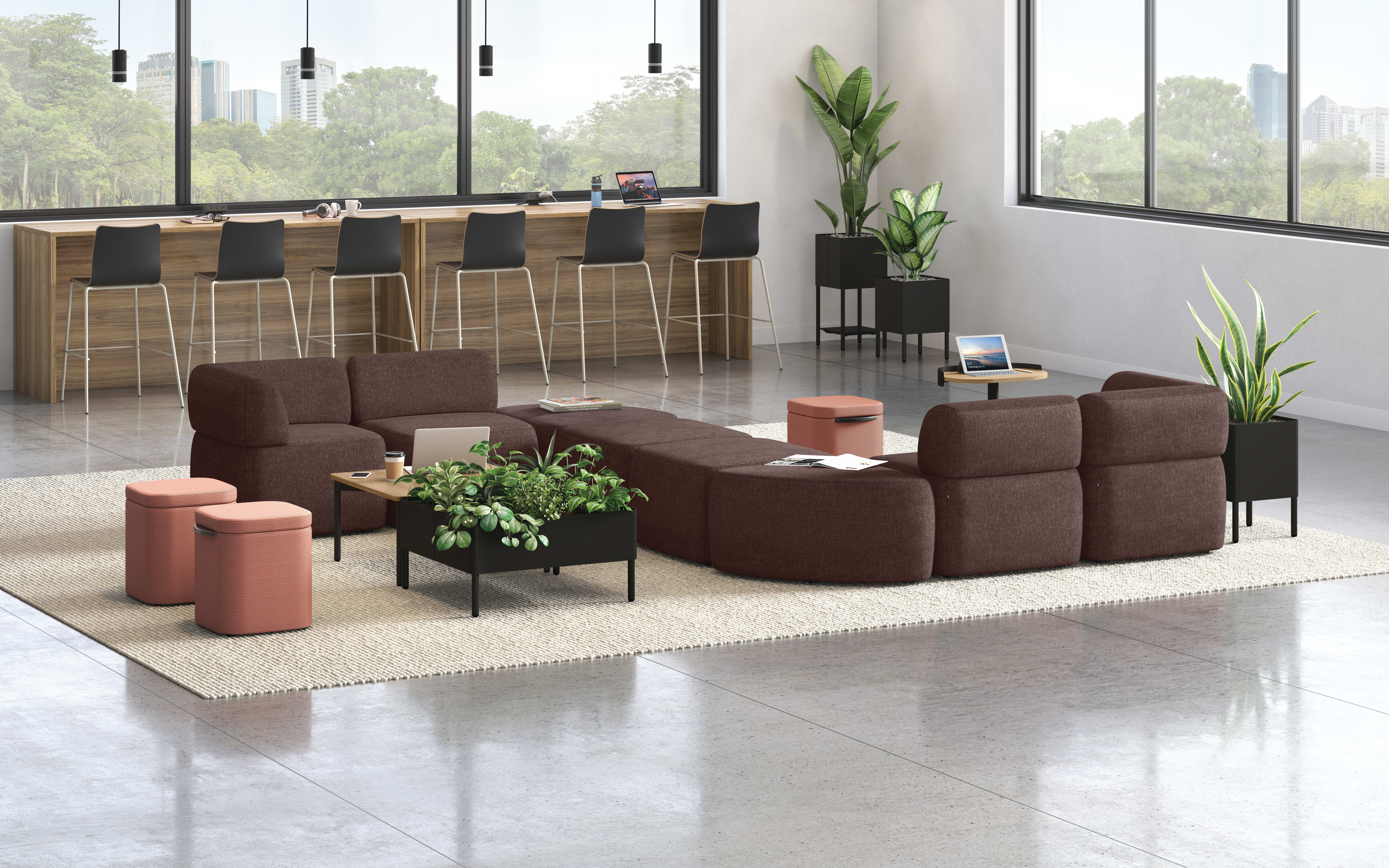 A modern and minimalist lobby or waiting area with comfortable burgundy sofas, potted plants, and a wooden reception desk against a backdrop of large windows overlooking a lush outdoor environment.