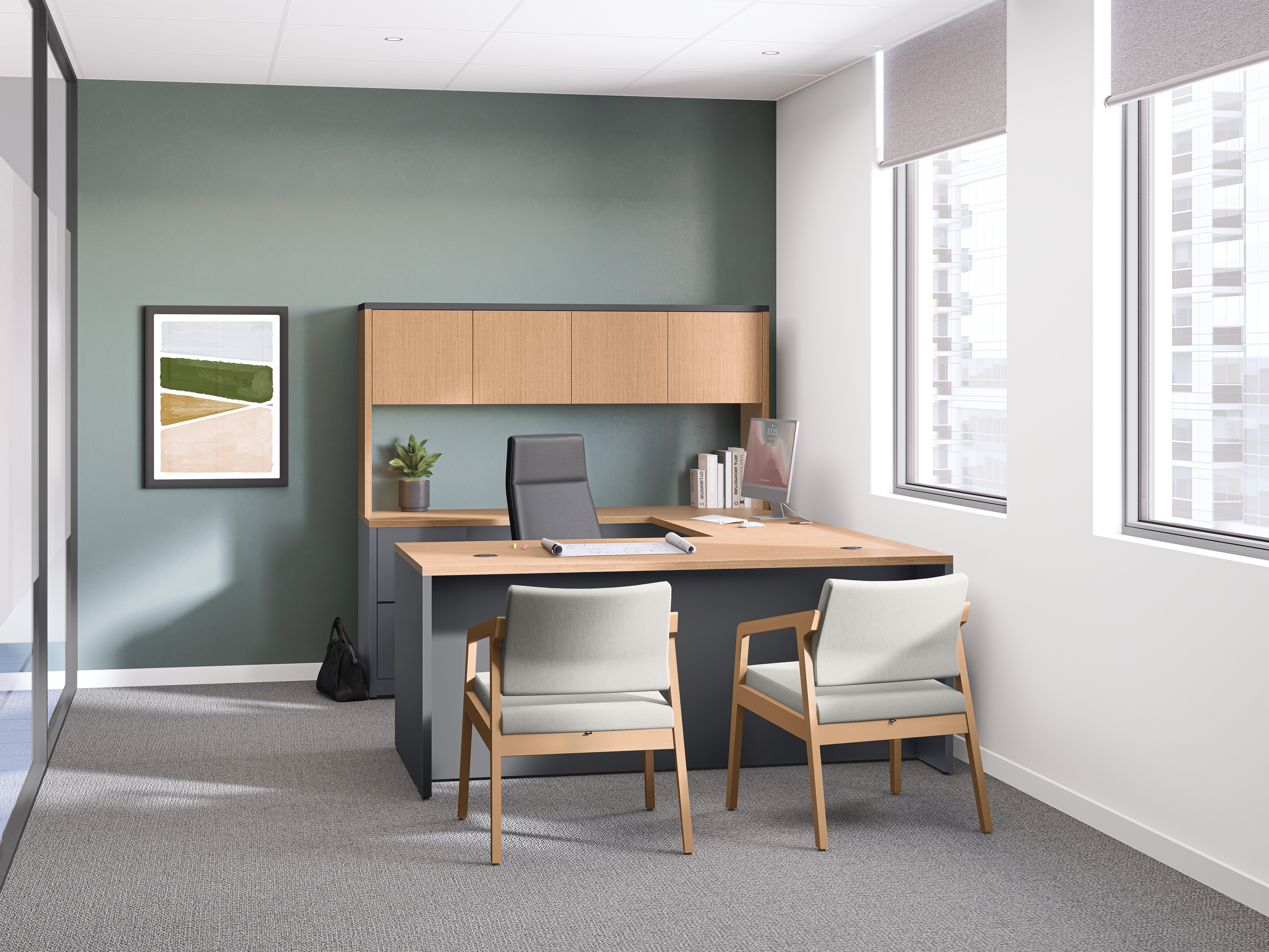 Modern private office with wood desk, overhead storage cabinet, two guest chairs, framed wall art, large windows, and soft daylight in a clean, contemporary workspace.