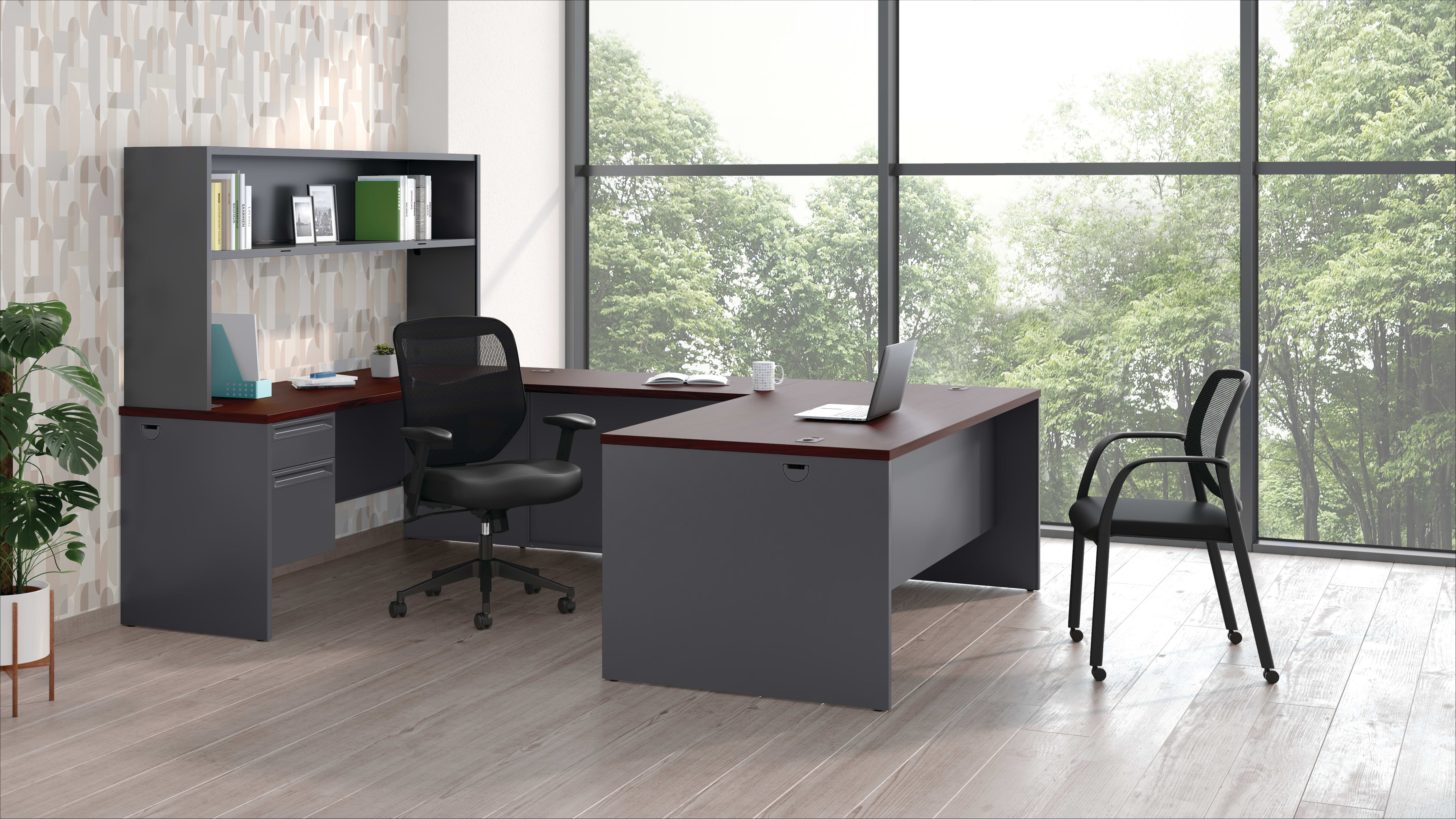 A modern and minimalist home office space with a dark-colored desk, shelving unit, and a chair in the foreground, set against a large window overlooking a lush, green outdoor environment.