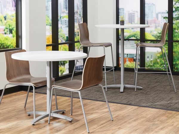 Between Standing and seated height tables with Ruck chairs in a café area