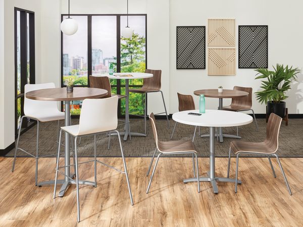 Between Standing and seated height tables with Ruck chairs in a café area