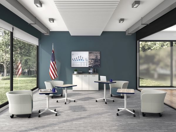 Huddle Laptop Tables with Flock Round Lounge Chairs socially distanced around a conference room.