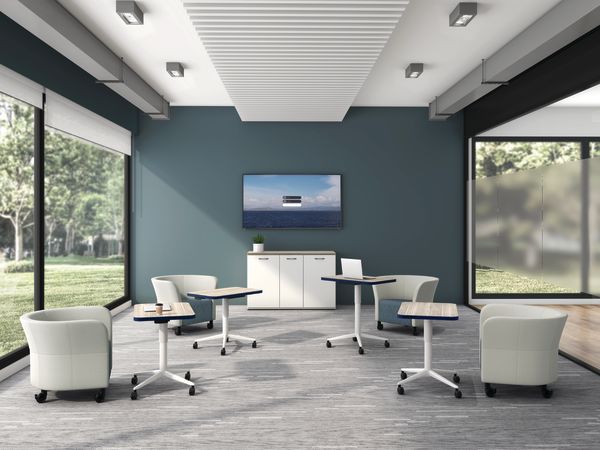 Huddle Laptop Tables with Flock Round Lounge Chairs socially distanced around a conference room.