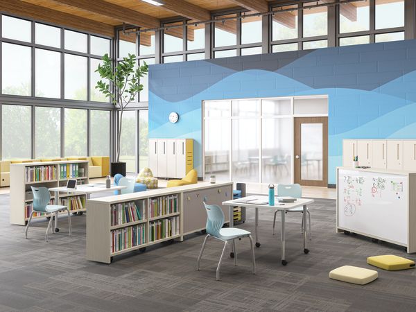 Open space outside of a classroom featuring Storyline bookcases and Build tables as a place for students to study.