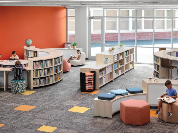 Storyline Bookcases and Bistro Tables with Confetti Floor Cushions and Lounges, Tangram Poufs, and Flock Minis.