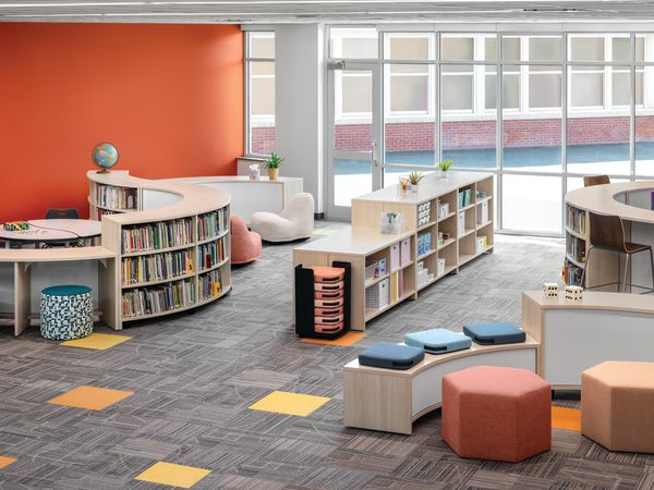 Storyline Bookcases and Bistro Tables with Confetti Floor Cushions and Lounges, Tangram Poufs, and Flock Minis.