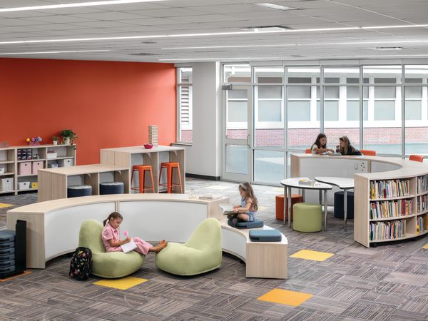 Storyline Bookcases and Bistro Tables with Confetti Floor Cushions and Lounges, and Flock Minis.