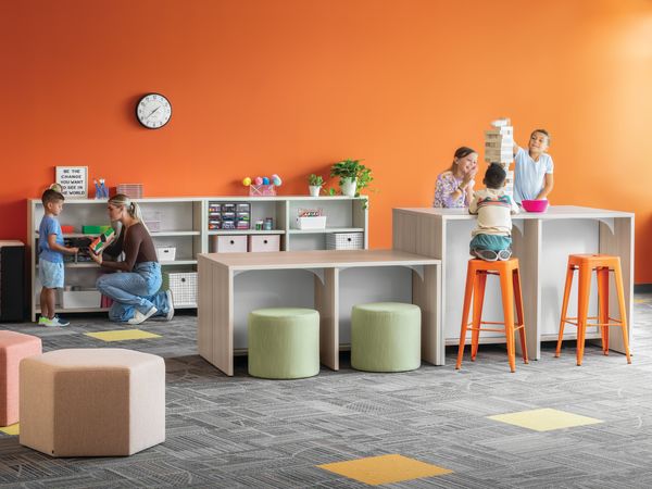 Storyline Linear Bookcases and Bistro Tables with Tangram Poufs and Flock Minis.