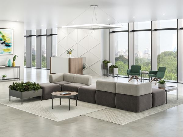 SoCo multi-fabric modular lounge in reception area with Sculpt occasional tables & planters near 10500 Series station and Mav seating.