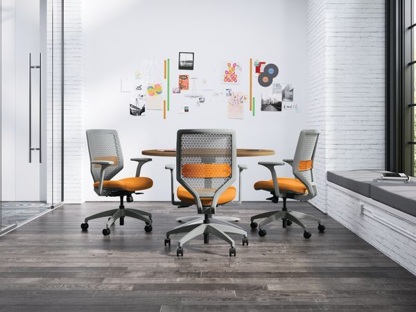 A small meeting room with a Preside circular table and Solve ReActiv back task chairs.