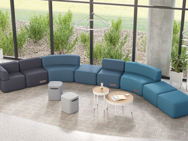 SoCo modular lounge in public space with Sculpt occasional tables & planters and Astir poufs.