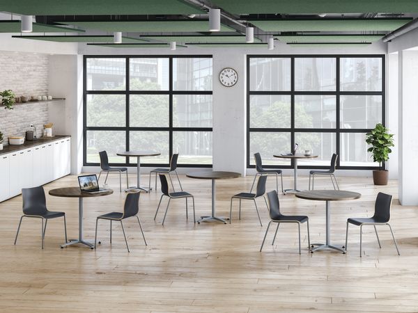 A café setting featuring round Between tables and Ruck wood seating.