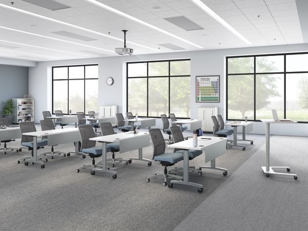 A classroom setting featuring Ignition task seating and Huddle training tables.