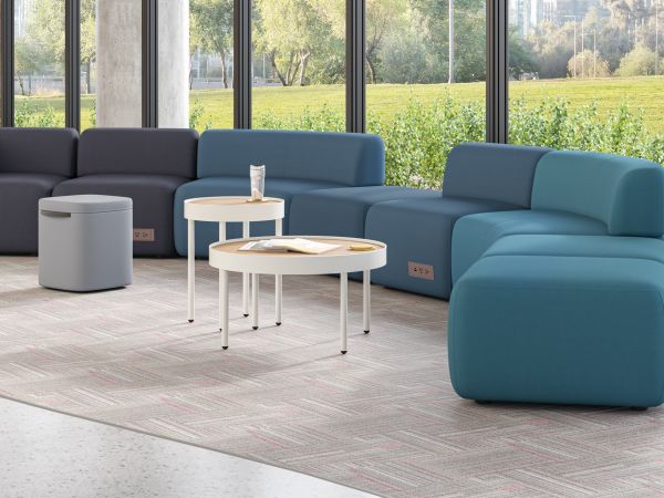 SoCo modular lounge in public space with Sculpt occasional tables & planters and Astir poufs.