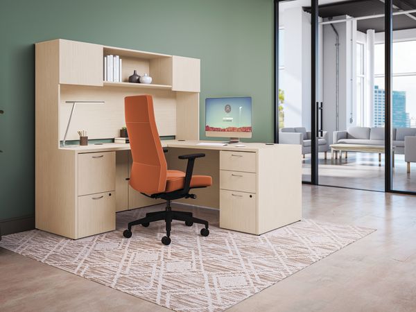 Private office featuring Mod L- shaped desk with high-back Cofi executive chair in orange fabric. 