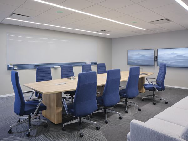 Preside conference table with Cofi task chairs,  Workwall markerboard tiles, and Astir