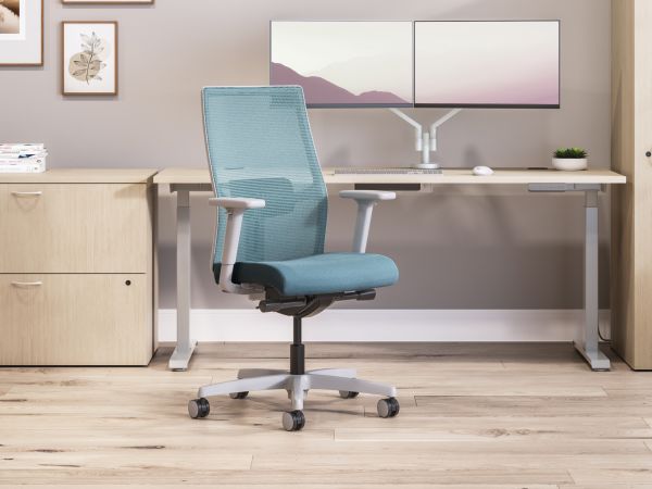 Private office featuring Mod desk with height adjustable table and Ignition task seating in blue fabric.