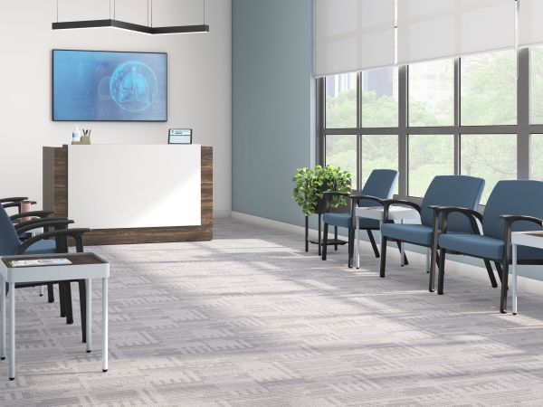 Healthcare waiting area with blue Soothe chairs and Sculpt tables and planters