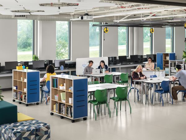 Students and teacher in a makerspace classroom with blue and green Smartlink chairs and blue Class-ifi storage solutions.
