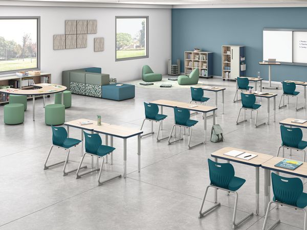 Classroom with flexible Build student desks, blue student chairs, and green soft seating.