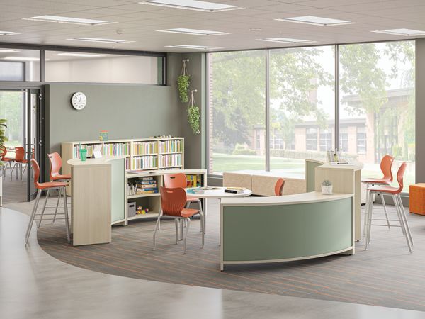 Open space outside of a classroom featuring Storyline bookcases and Build tables as a place for students to study.