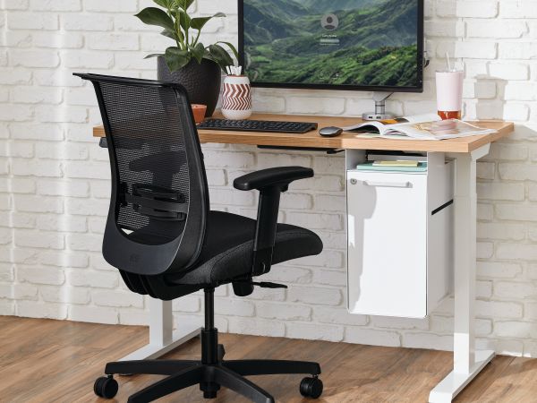 Two white Coordinate Height-Adjustable Bases paired with Coze desk tops and Convergence Task chairs in a small office setting