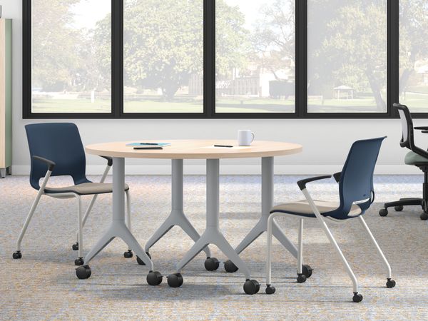Open workstation view of Motivate 4-leg stacking and flex-back chair with Contain wardrobe locker and Motivate half-round table