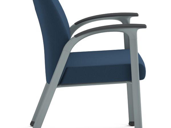 Blue cushioned guest chair with textured fabric, metal frame, and integrated armrests, designed for modern office or waiting areas.