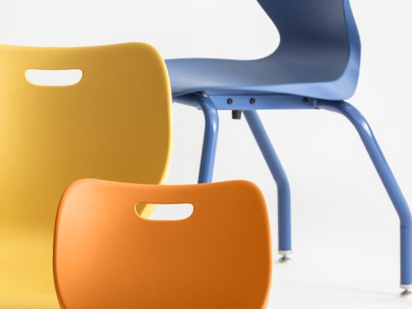 A collection of colorful, modern chairs in various shades of green, blue, yellow, and red, arranged against a plain white background.